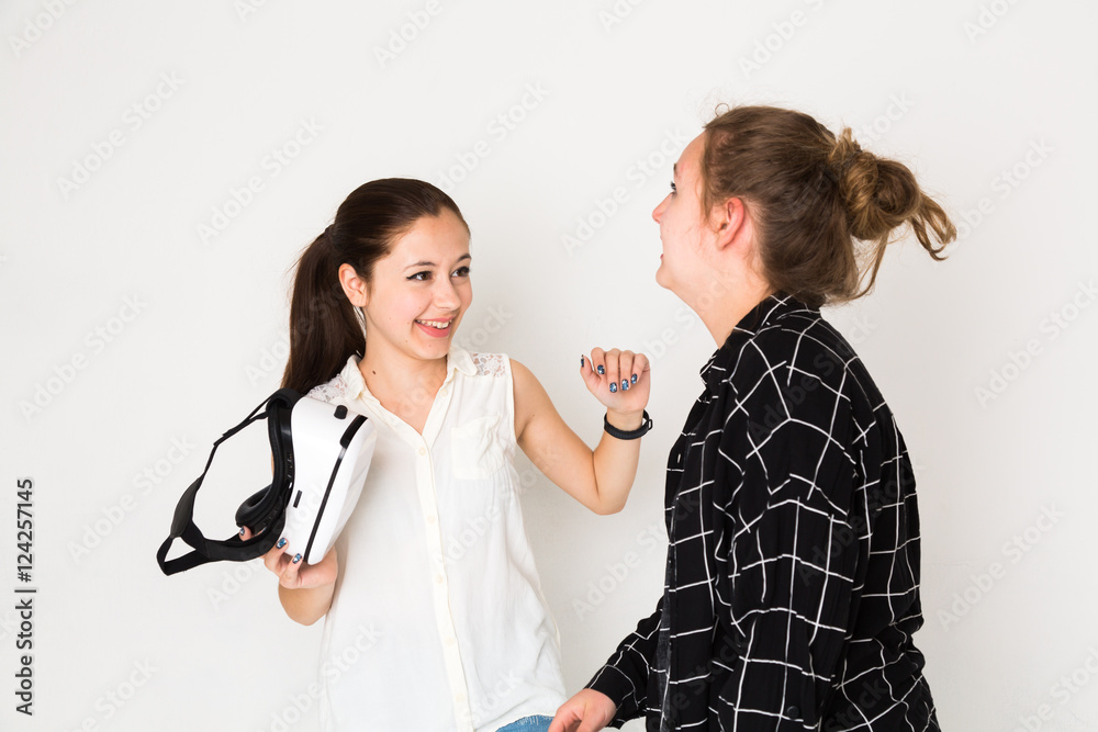 Happy friends holding a head mounted display Happy friends holding a head mounted display