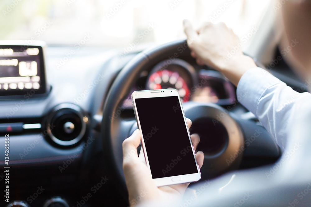man using phone while driving the car (selective focus) - transportation and vehicle concept