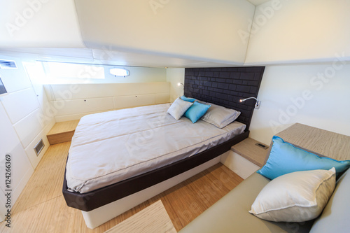 interior of luxury motoryacht, bedroom cabin photo