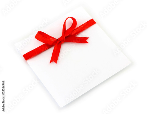 Sheet with red holiday bow on white background