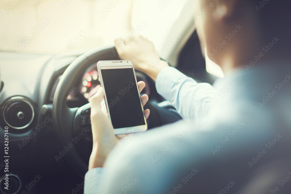 man using phone while driving the car (selective focus) - transportation and vehicle concept - vintage tone