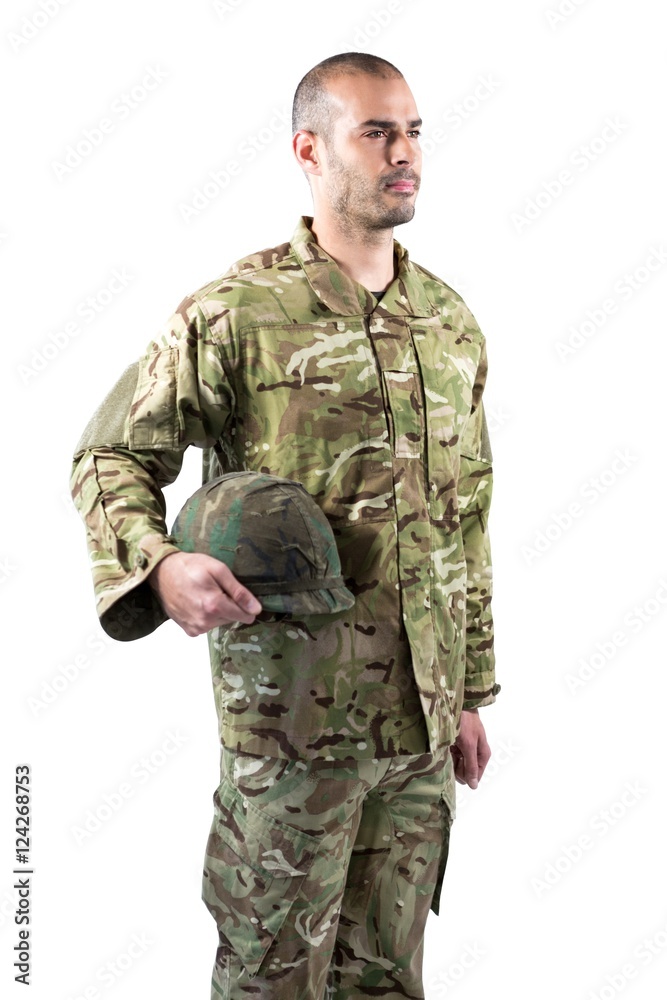 Confident soldier standing with a helmet