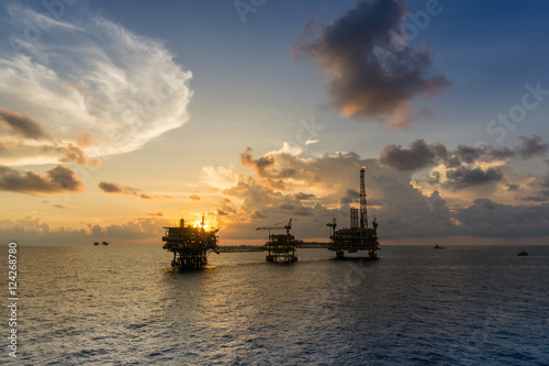 Silhouette of oil rig platform during sunset at oilfield in Malaysia