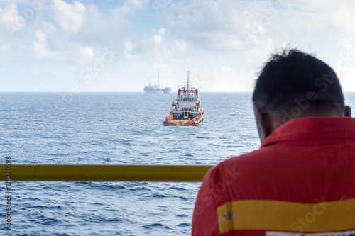 An offshore worker monitoring the anchor handling on construction barge at oilfield Malaysia