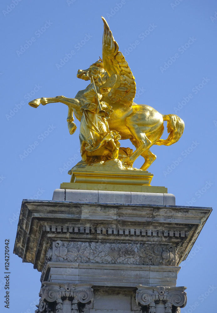 The golden statues on Alexandre III bridge in Paris