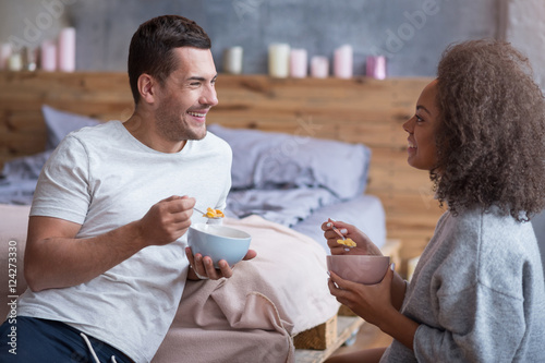 Happy couple having breakfast together photo