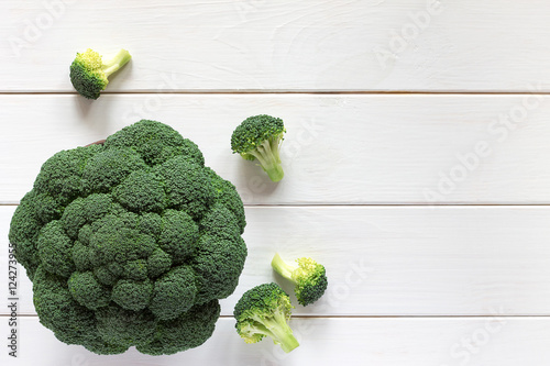 Fresh broccoli on a wooden table, top view.