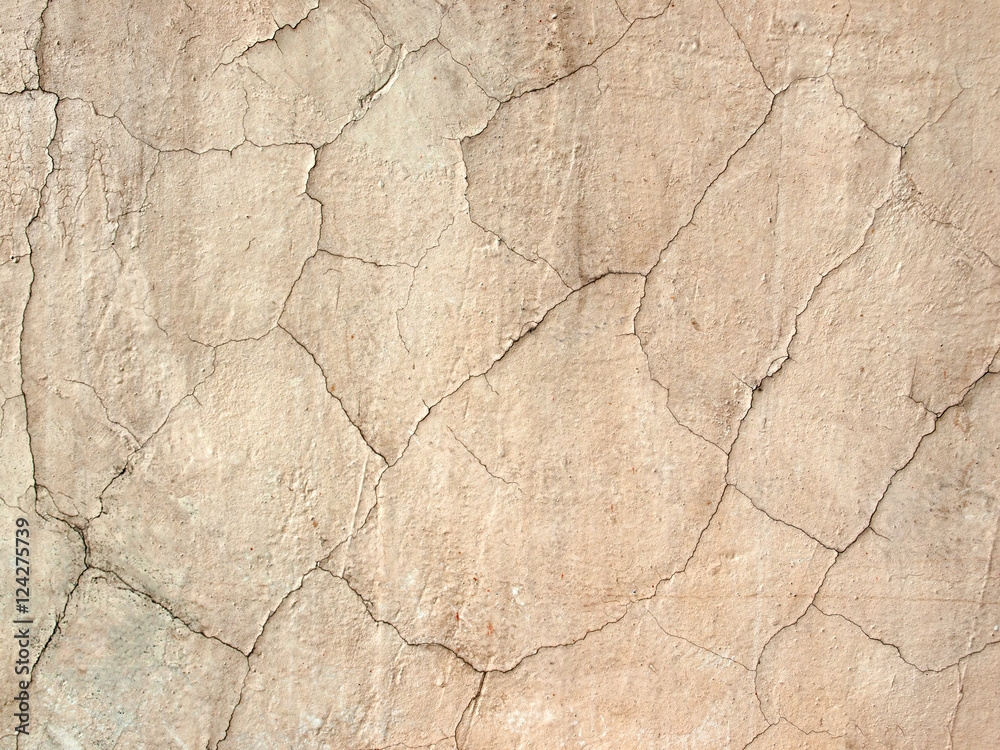 Texture beige cement wall with cracks closeup Texture beige cement wall with cracks closeup