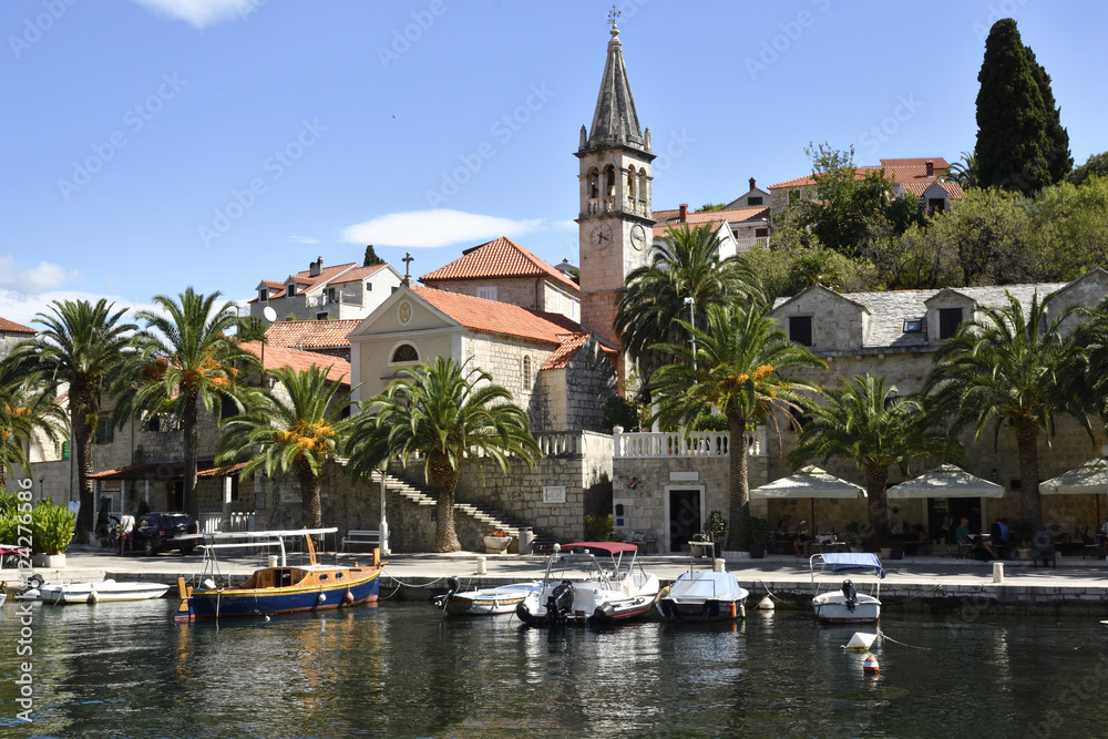 Fototapeta premium Harbor in the little village Splitska on Brac Island in Croatia, with some small boats and the old church.