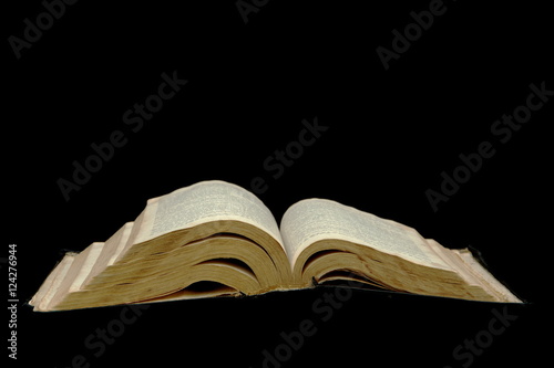Open Bible isolated on a black background © Anatoliy Mak