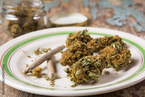 Marijuana buds and joints in the white plate photo