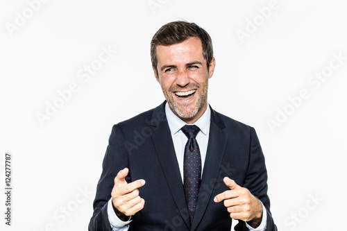 successful bearded businessman laughing and smiling with relaxed hand gesture