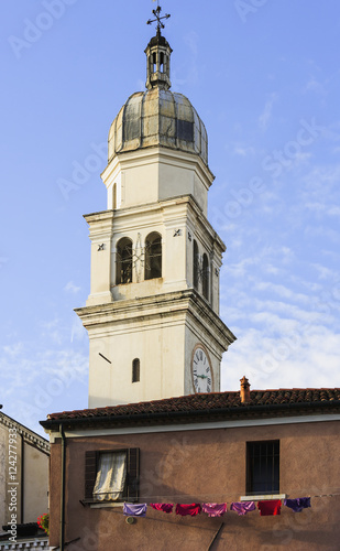 Clock Tower On A Church And Laundry Hanging To Dry On A Clothesline Outside A House; Venice, Italy photo