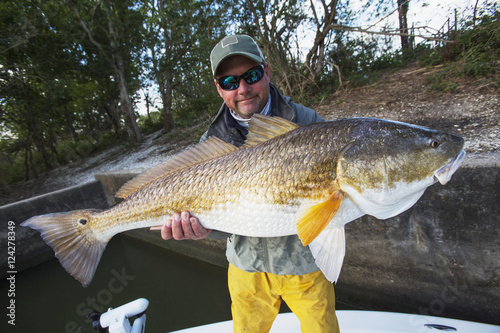 Man holding a redfish (sciaenops ocellatus);Venice louisiana united states of america photo