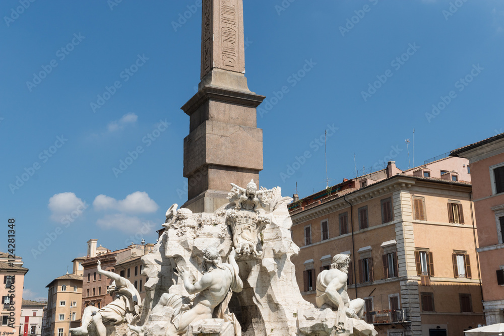 Detail of the Egyptian obelisk and the Fountain of the four Rivers in the middle of Piazza Navona, Rome, Italy