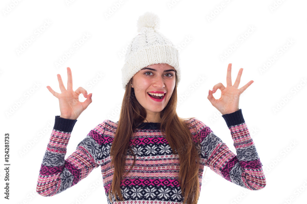 Woman in sweater and white hat showing okay Woman in sweater and white hat showing okay