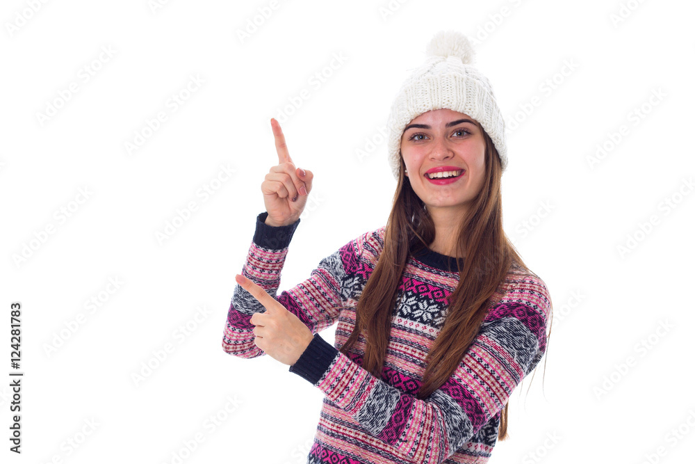 Woman in sweater and white hat pointing up Woman in sweater and white hat pointing up