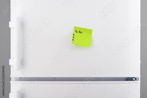 To do list on green note paper on white refrigerator