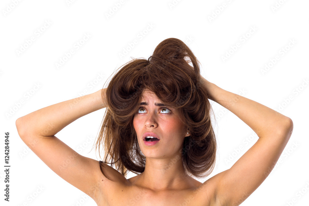 Confused woman holding her tangled hair