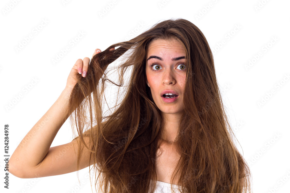 Woman touching her tangled hair Woman touching her tangled hair