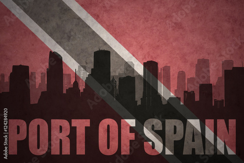 abstract silhouette of the city with text Port of Spain at the vintage trinidad and tobago flag