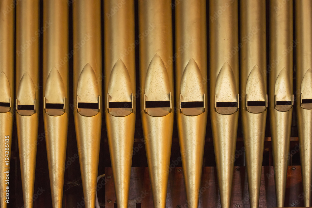 Close up of the gold pipes of a pipe organ; Northumberland, England Close up of the gold pipes of a pipe organ; Northumberland, England