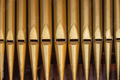 Close up of the gold pipes of a pipe organ; Northumberland, England