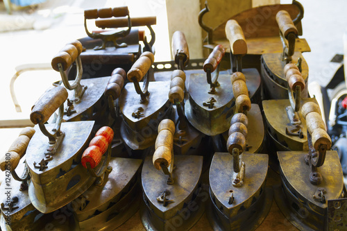 Old irons for sale at the Triwindu Market, Surakarta (Solo), Central Java, Indonesia photo
