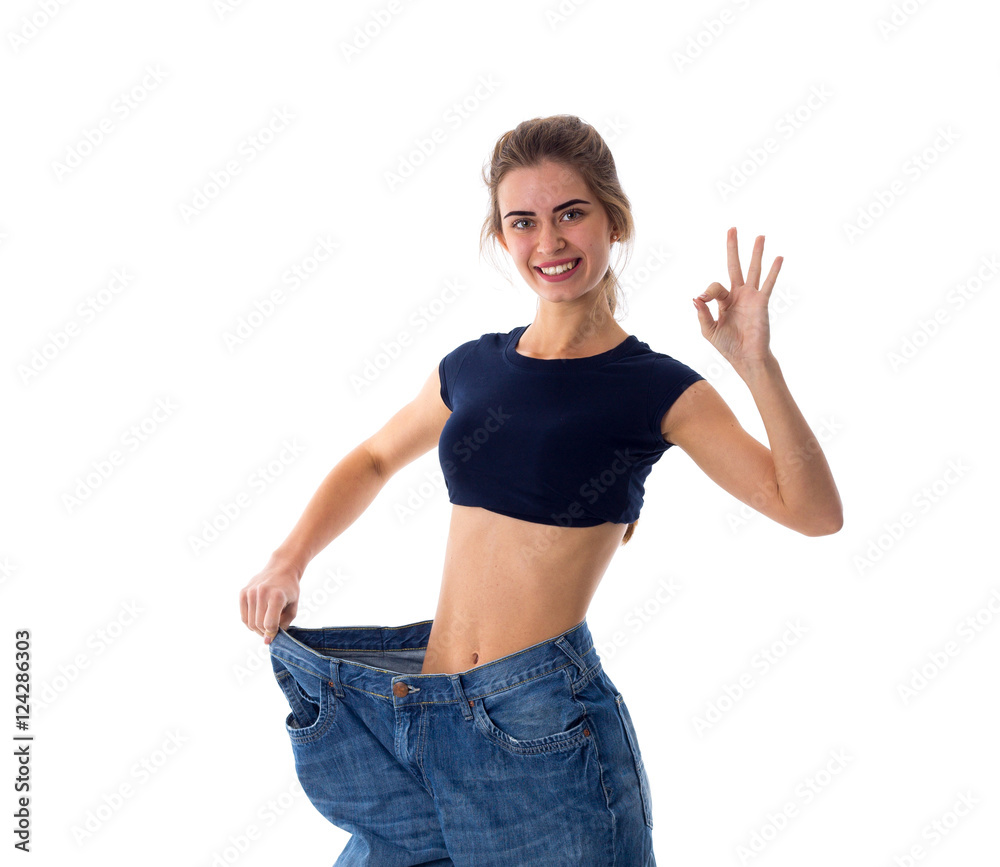 Woman wearing jeans of much bigger size Woman wearing jeans of much bigger size