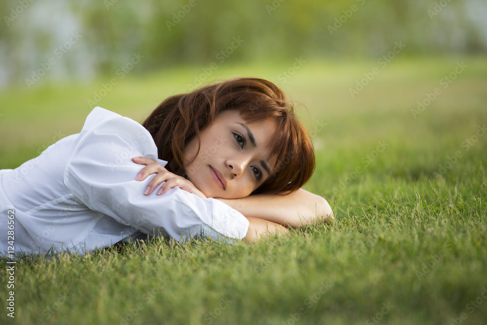 Young woman taking time for herself in a park; Edmonton, Alberta, Canada Young woman taking time for herself in a park; Edmonton, Alberta, Canada