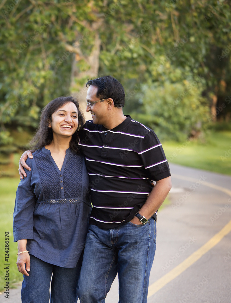 Husband and wife spending quality time together outdoors in a park; Edmonton, Alberta, Canada Husband and wife spending quality time together outdoors in a park; Edmonton, Alberta, Canada