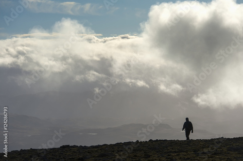 A man walks out of the clouds from the summit of Maol Chean-dearg; Torridon, Scotland photo