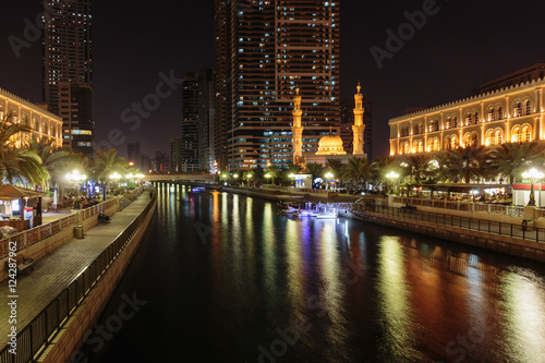 SHARJAH, UAE - OCTOBER 29, 2013: Night view of Sharjah. Sharjah is located along northern coast of Persian Gulf on Arabian Peninsula