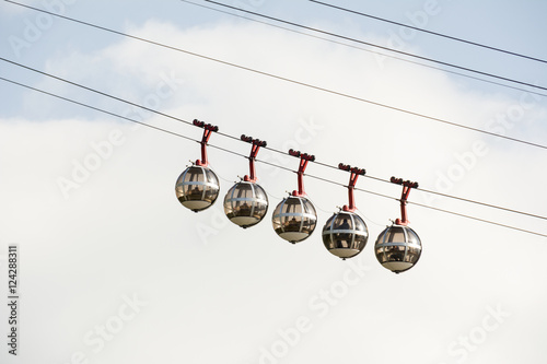 Bubble gondola against blue sky and white cloud; Grenoble, France