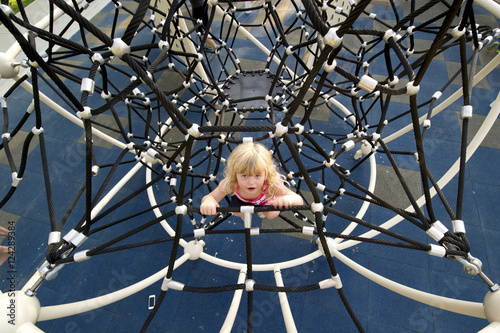 Young girl climbing on playground equipment; Lethbridge, Alberta, Canada photo