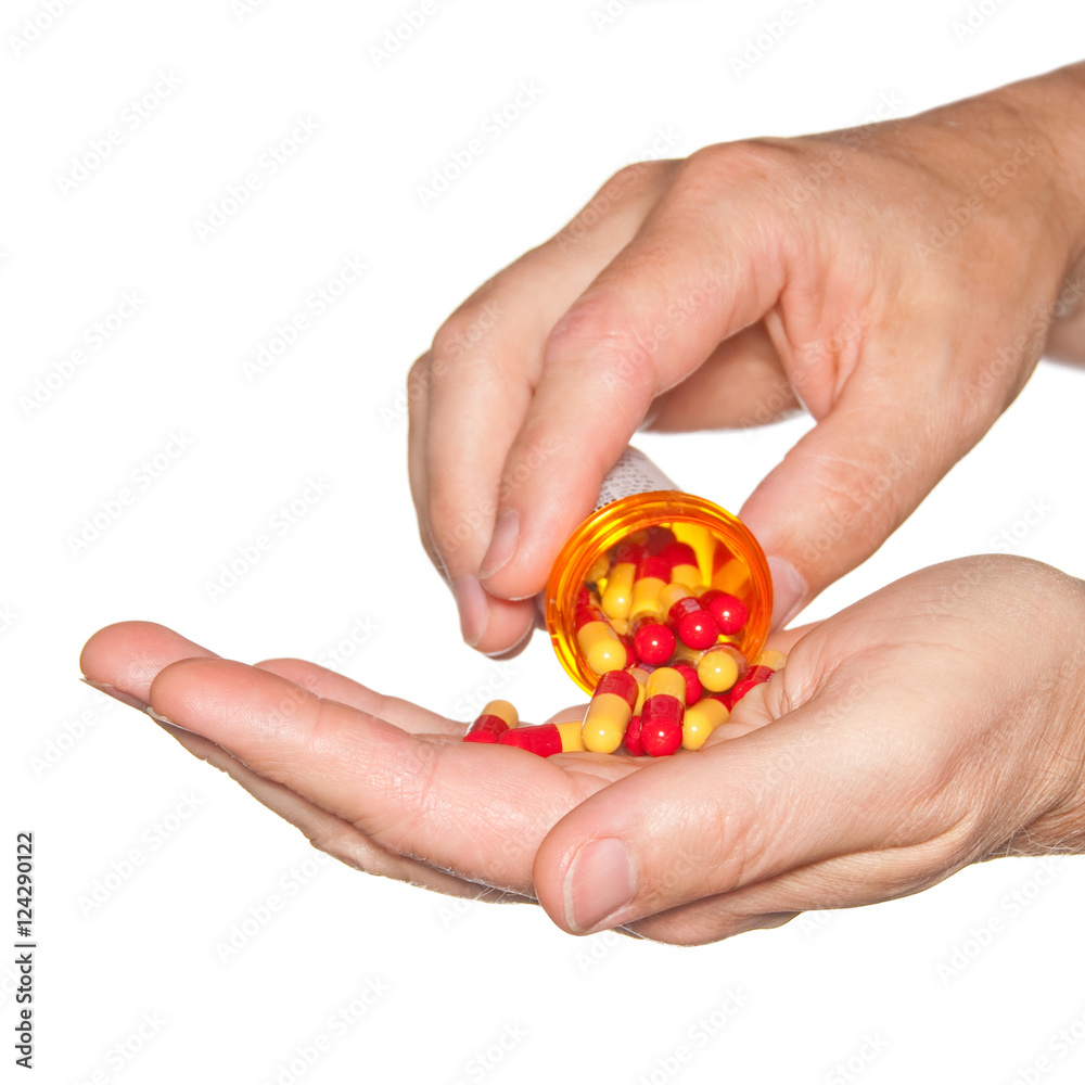 Closeup on man's hands with pills and pill container. Closeup on man's hands with pills and pill container.