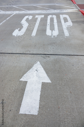 Stop sign on street, with arrow