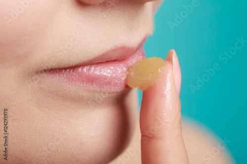 Принти на полотні woman applying balsam for lips