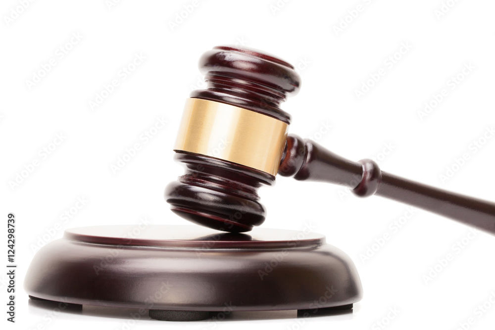 Close up studio shot of judge gavel and soundboard on white