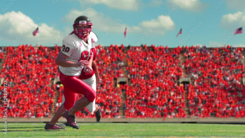 Football bluescreen, a football player catches a football in a stadium, slow motion.