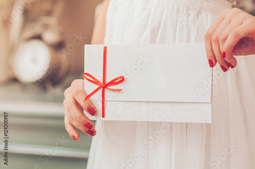 Gift card - closeup of woman showing sign card.