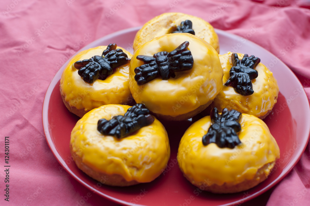 Colourful iced orange Halloween doughnuts Colourful iced orange Halloween doughnuts