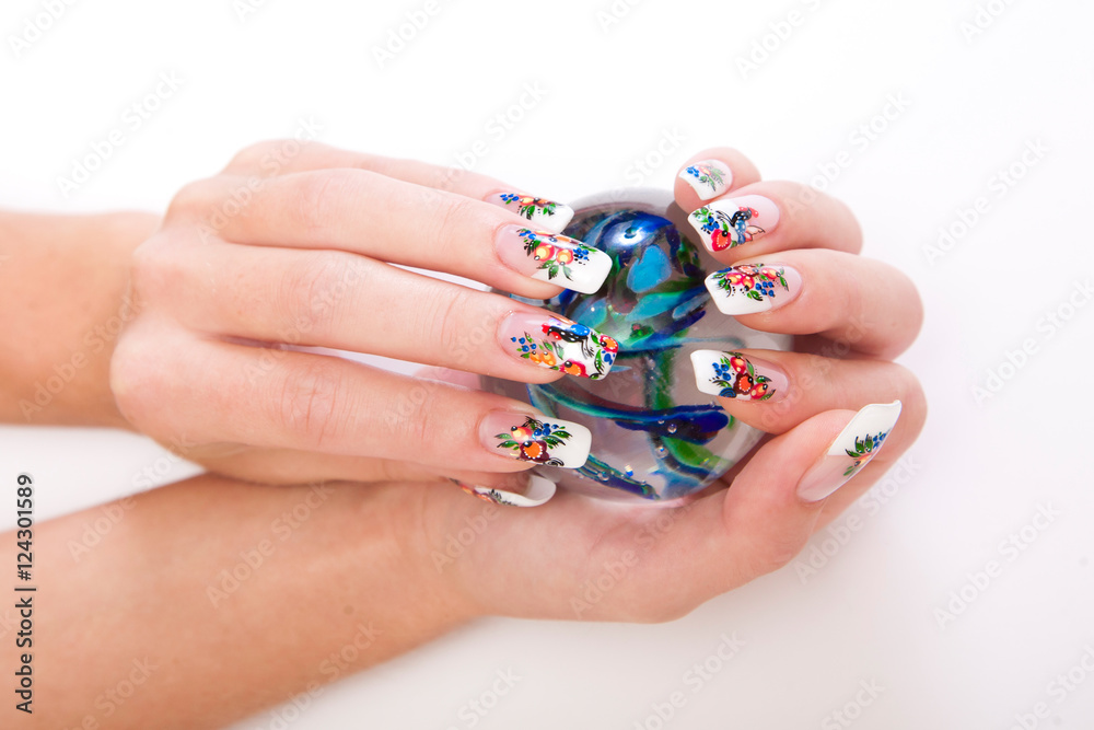 Beautiful female hands with nice art manicure on white background
Beautiful female hands with nice art manicure on white background