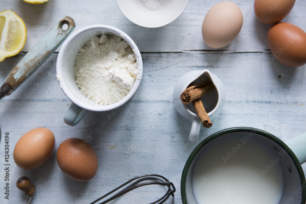 Ingredients for making pancakes, including eggs, flour cinnamon Ingredients for making pancakes, including eggs, flour cinnamon