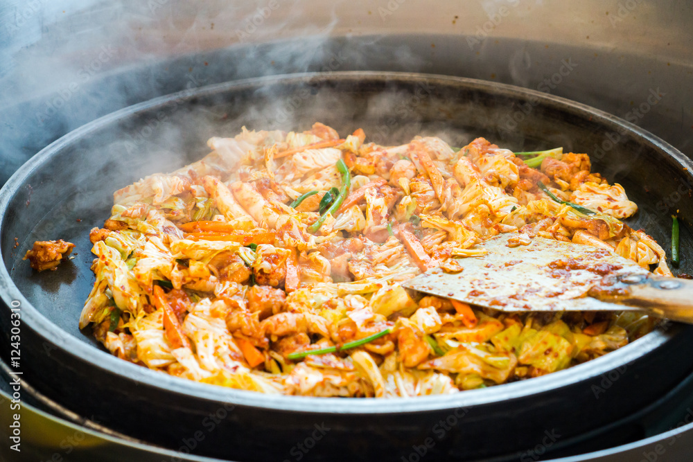 One of Korean favorite : Korean spicy stir fried vegetable, chicken and Korean spicy sauce (Gochujang) in big hot pan know as Dak Galbi One of Korean favorite : Korean spicy stir fried vegetable, chicken and Korean spicy sauce (Gochujang) in big hot pan know as Dak Galbi