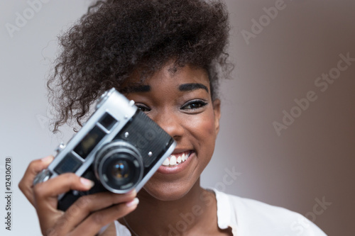 retty young girl holding a vintage camera © Myvisuals