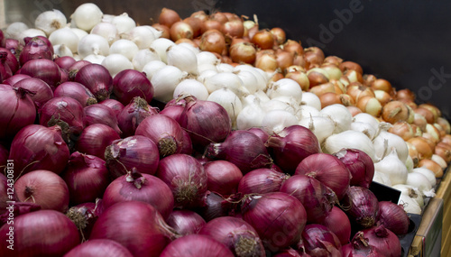 Variety of onions in red, white and brown for sale in market