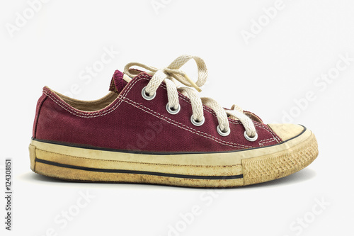 Old red sneaker isolated on white background.