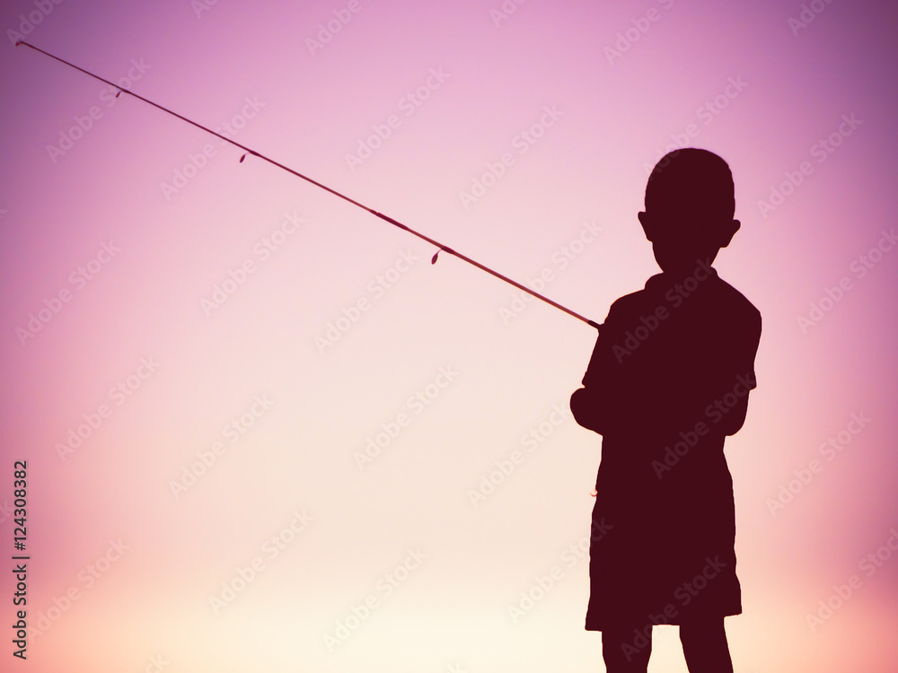 Boy fishing, silhouette concept Stock Photo