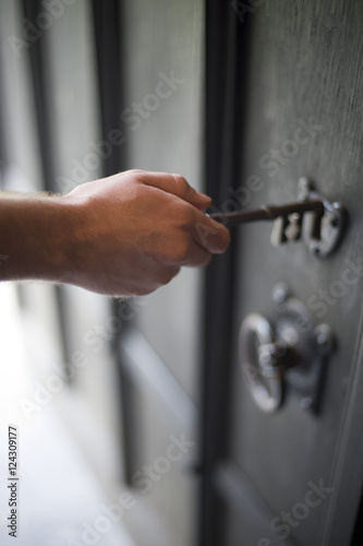 Person Unlocking a Door